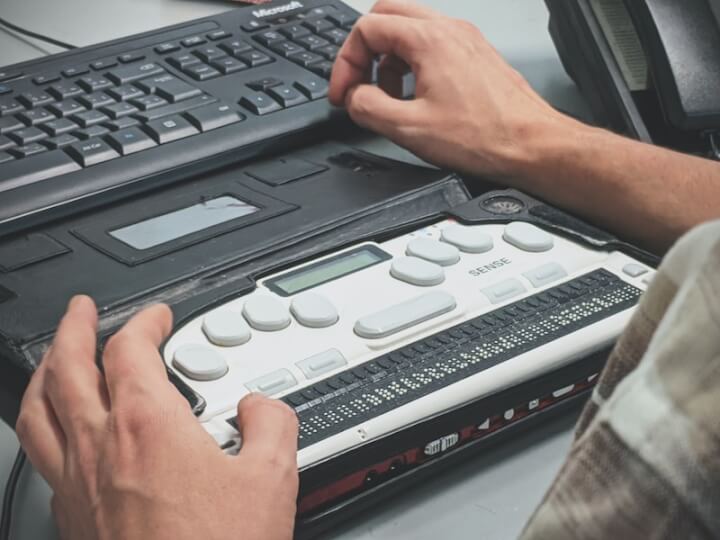 person using braille writer
