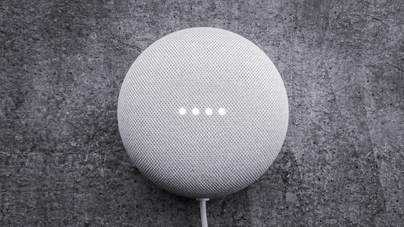 round white portable speaker on black textile