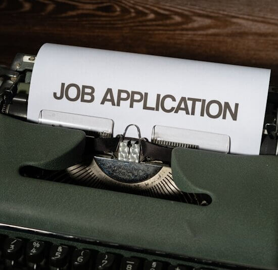 a typewriter with a job application printed on it