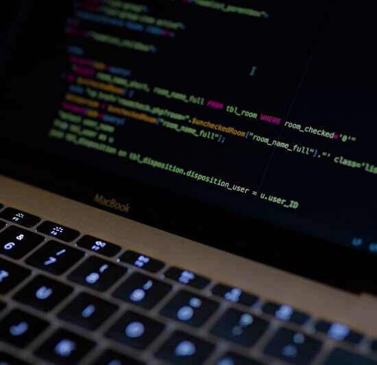 MacBook Pro with images of computer language codes